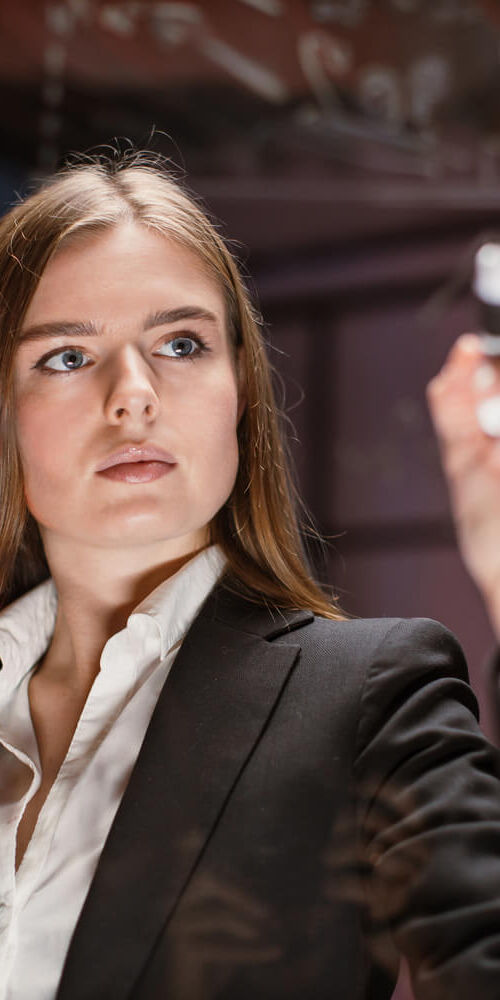 young-focused-woman-writing-on-glass-office-board-2022-05-30-19-29-42-utc (2) (1)